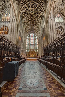 the east end with a huge stained glass window and vault of a net design