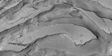 Tilted layers formed from ground collapse, as seen by HiRISE under HiWish program