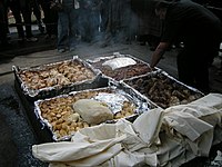 A Hāngī being prepared, a New Zealand Māori method of cooking food for special occasions using hot rocks buried in a pit oven