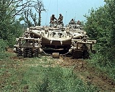 A remotely controlled Panther armoured mine clearing vehicle leads a column down a road in Bosnia and Herzegovina, 16 May 1996.