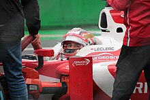 Leclerc looking out of his Dallara GP2/11 with his visor raised before the 2017 Monza Formula 2 round