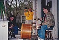 Band on porch: clarinet, trombone with mute, drums