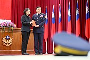 Tsai Ing-wen with the ROC flags in the background.