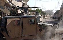 Picture of a soldier in a Humvee