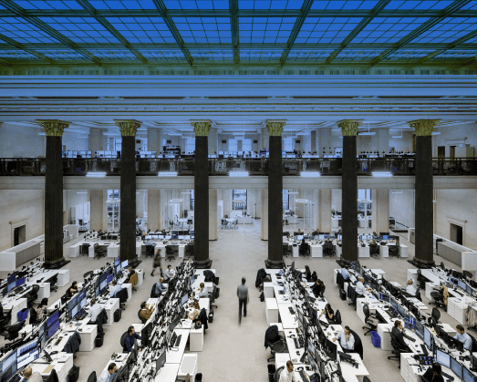 Expansive bank office location with rows of desks and employees