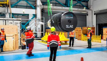 The LSST Camera is lifted out of its shipping crate on the third level of Rubin Observatory.