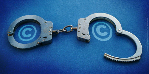 Handcuffs with copyright symbols inside the cuffs.