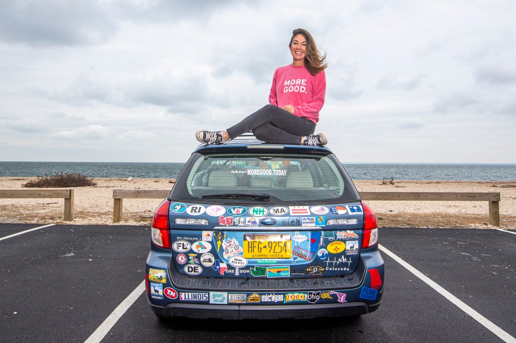 Mary Latham sitting on top of a car