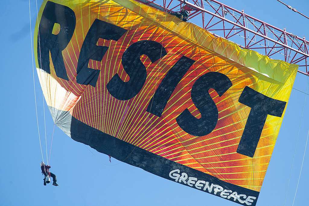 Resist Trump Banner Action in Washington D.C. Greenpeace activists deploy a banner on a construction crane near the White House reading "RESIST" on President Trump's fifth day in office.The activists are calling for those who want to resist Trump's attacks on environmental, social, economic and educational justice to contribute to a better America.