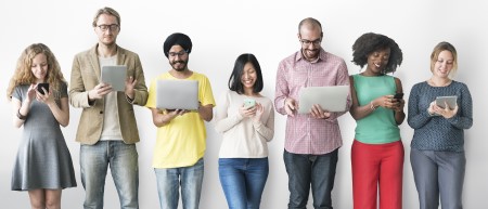 Seven people use phones, tablets, and laptops