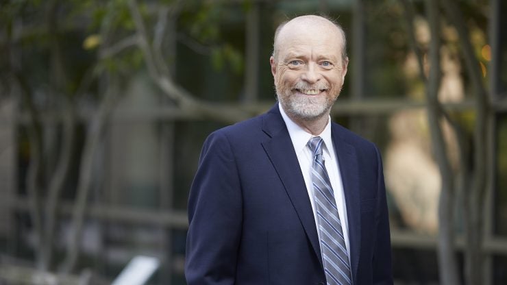 A man in a blue suit, smiling