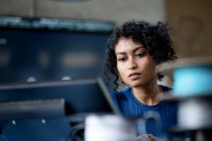 A decorative image of a person working on a computer