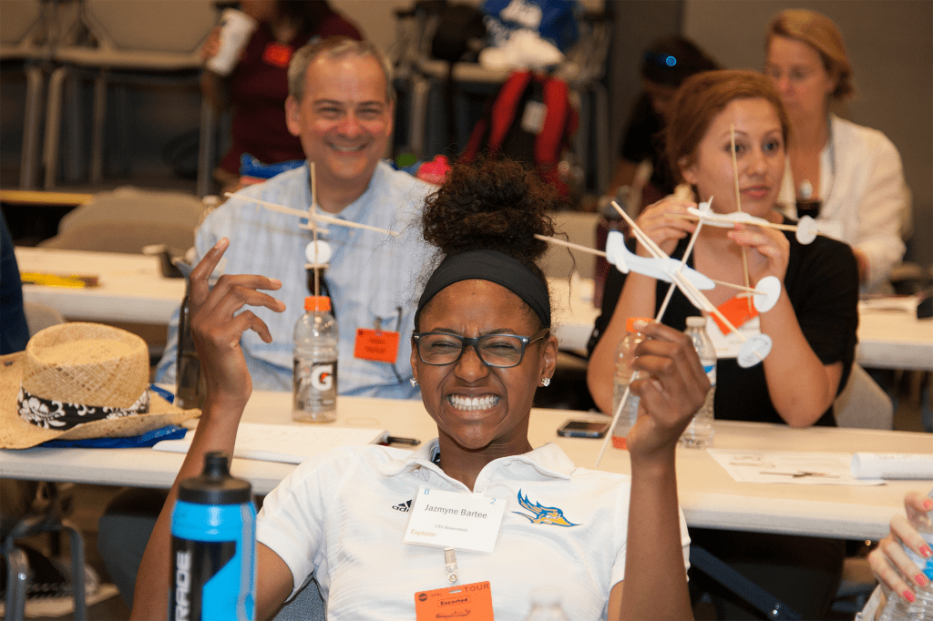 California State University student Jazmyne Bartee holds a model plane she built