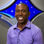 A portrait of Kennedy Space Center's Denton Gibson with the Launch Services Program insignia in the background.