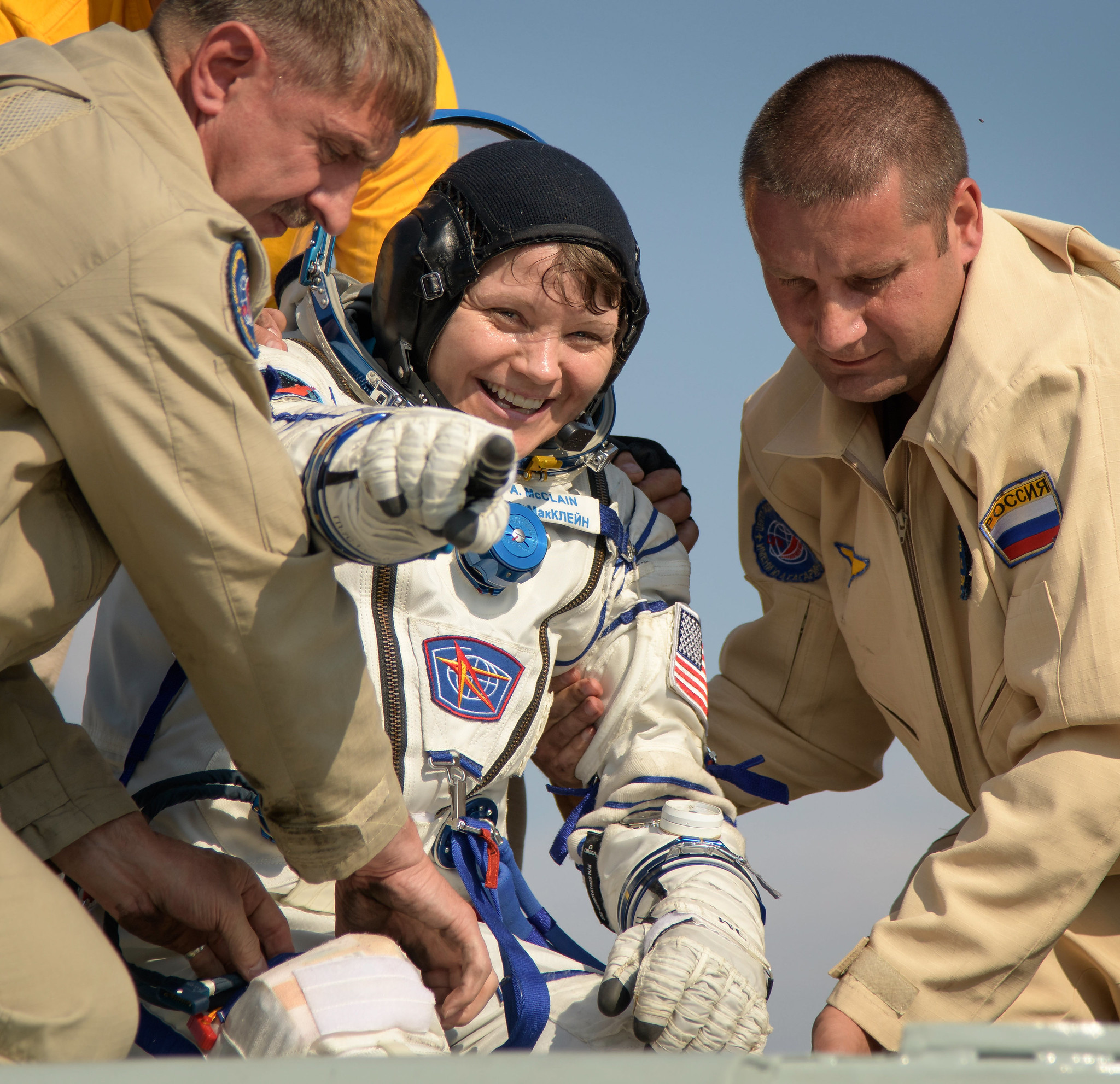 NASA astronaut Anne McClain is helped out of the Soyuz MS-11 spacecraft