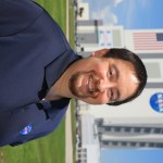 A photo of Kennedy Space Center's Slade Peters with the Vehicle Assembly Building in the background.