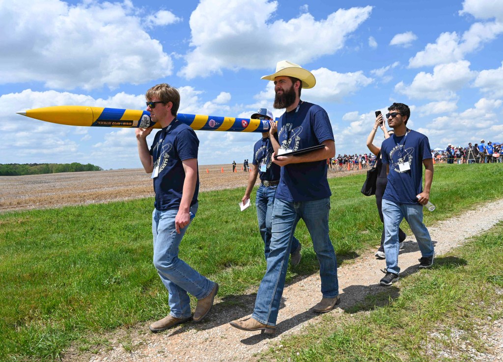 Group of students carry their rocket at the 2023 Student Rocket Launch Week challenge.