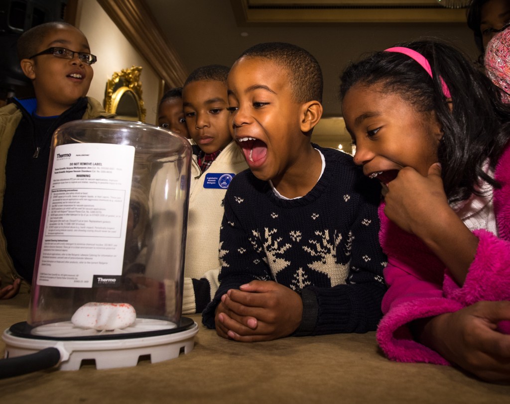 Group of children excited by a science experiment