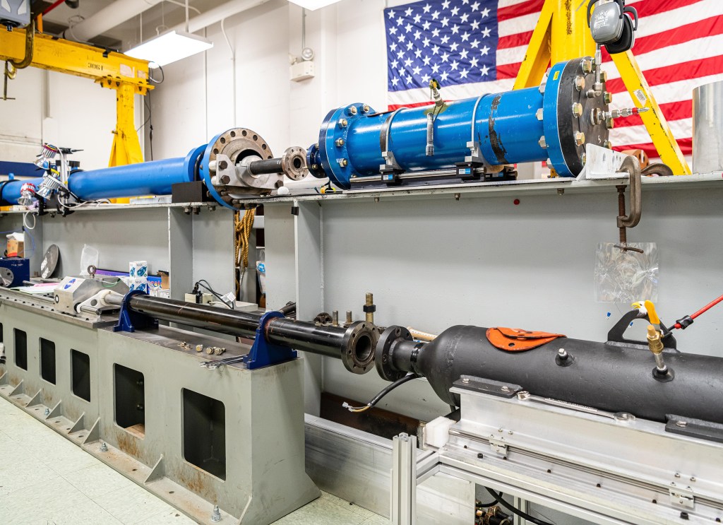 inside the lab with the large gas gun barrels.