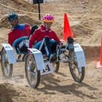 Two students man a rover built for the Human Exploration Rover Challenge (HERC).