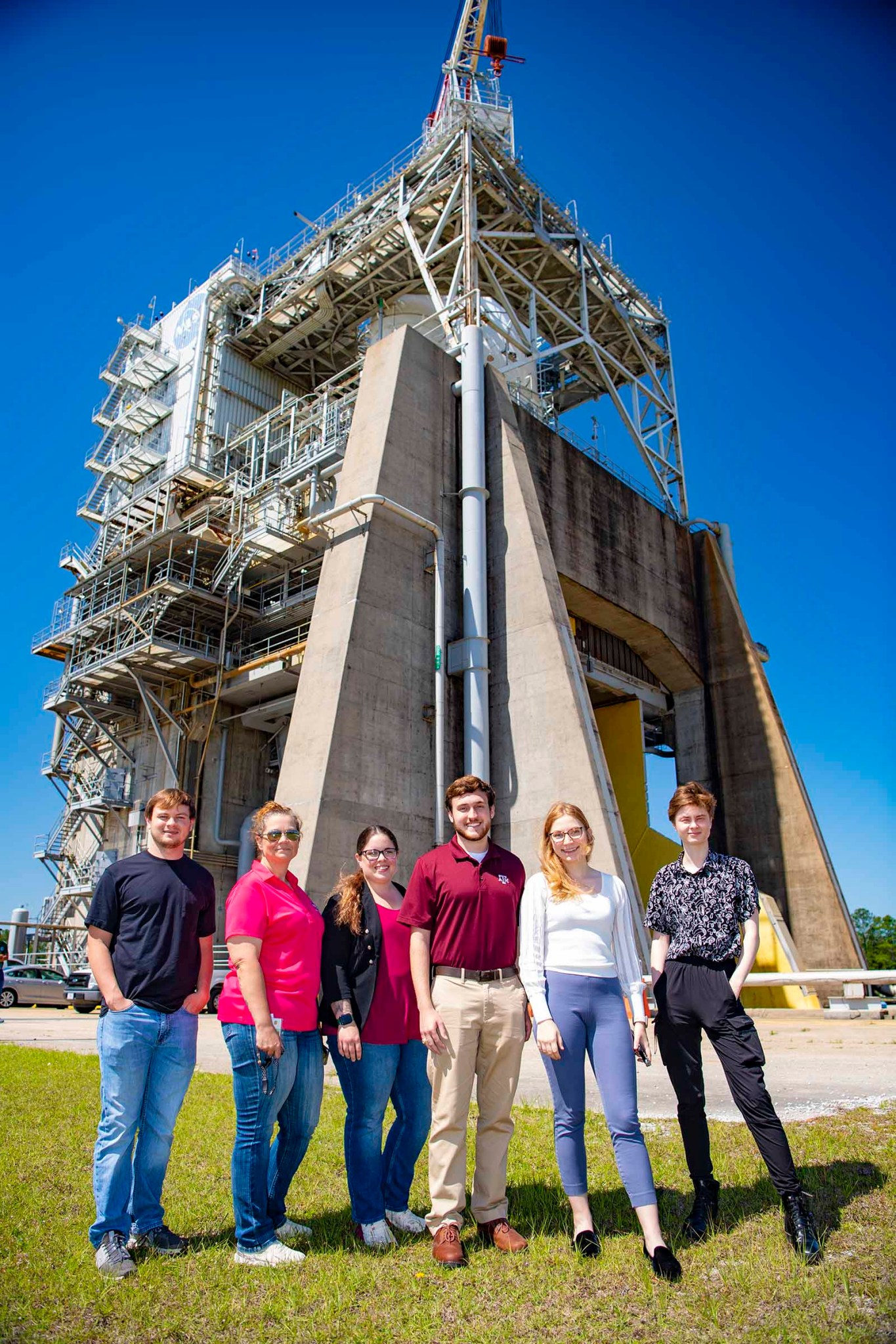 Student interns standing in front of Fred Haise Test Stand