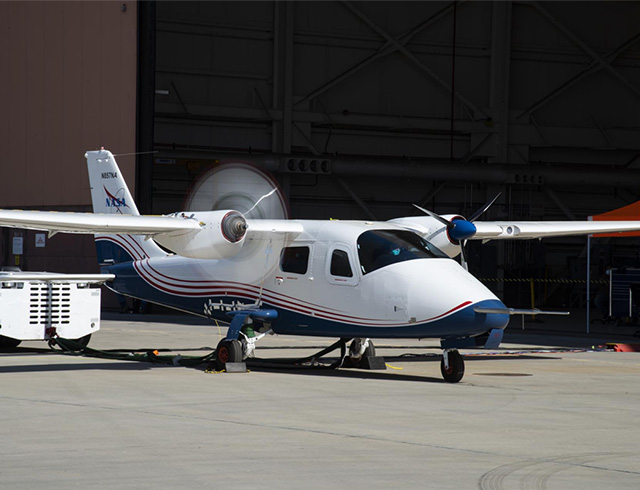 NASA's all-electric X-57 Maxwell continues to undergo high-voltage ground testing with successful spinning of the propellers under electric power at NASA's Armstrong Flight Research Center in California. The principal goals of the X-57 Project are to share the X-57 design and airworthiness process with regulators and standards organizations; and to establish the X-57 as a reference platform for integrated approaches of distributed electric propulsion technologies.