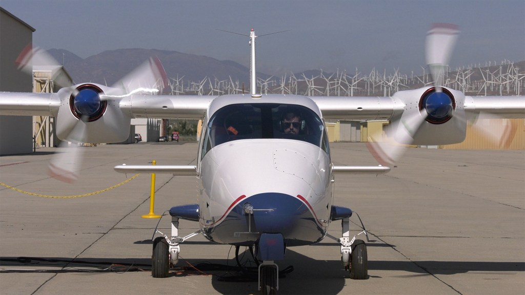 Ohm's Law cover image shows an image of the X-57 images with two of it's propeller's turned on.