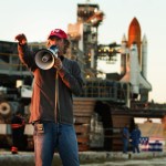 Michael Bay works at Launch Pad 39A with space shuttle Discovery in the background during filming of "Transformers: Dark of the Moon" while the production team was at NASA's Kennedy Space Center in October 2010.