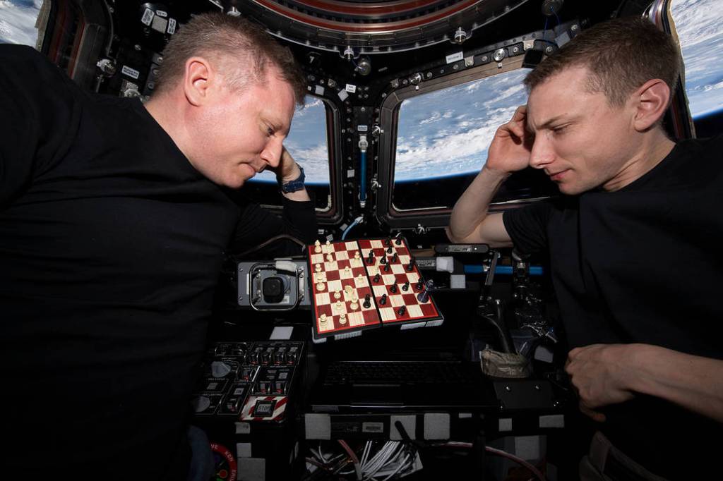 Cosmonaut Sergey Prokopyev and astronaut Woody Hoburg play chess