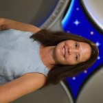 A portrait of Kennedy Space Center's Laura Ulrich with the Launch Services Program insignia in the background.