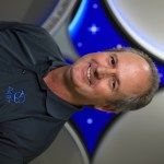 A portrait of Kennedy Space Center's Ralph Mikulas with the Launch Services Insignia in the background.