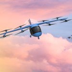 Artist concept of unmanned eVTOl and drone in flight against a pink sky.