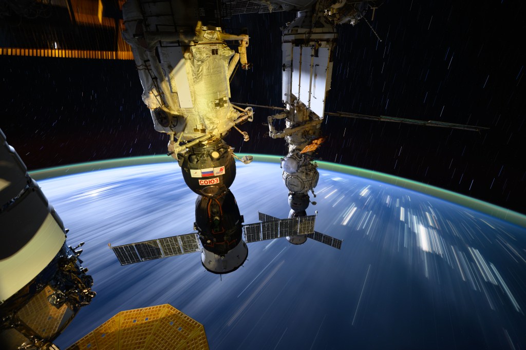 The long exposure photograph taken by NASA astronaut Matthew Dominick shows star trails, streaks of city lights, and two Roscosmos crew ships, the Soyuz MS-26 docked to the Rassvet module (foreground) and the Soyuz MS-25 (background) docked to the Prichal docking module, as the International Space Station orbited 265 miles above central China.