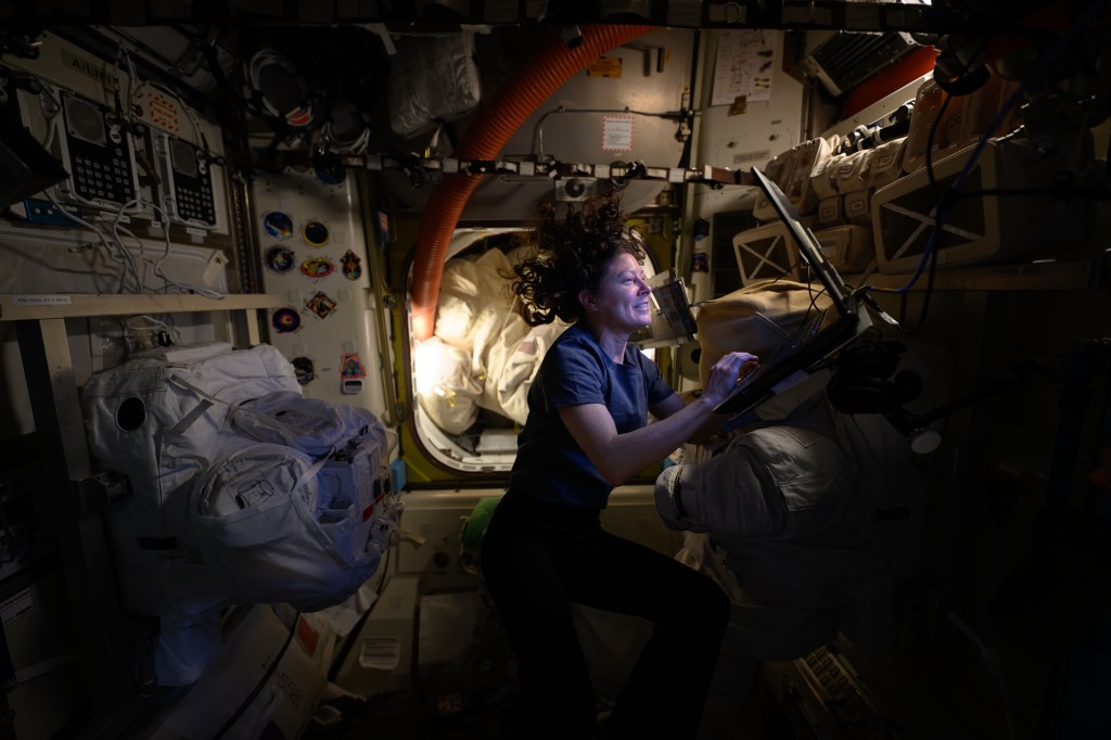 NASA astronaut and Expedition 71 Flight Engineer Tracy C. Dyson works on a computer inside the International Space Station's Quest airlock where spacewalks are staged.