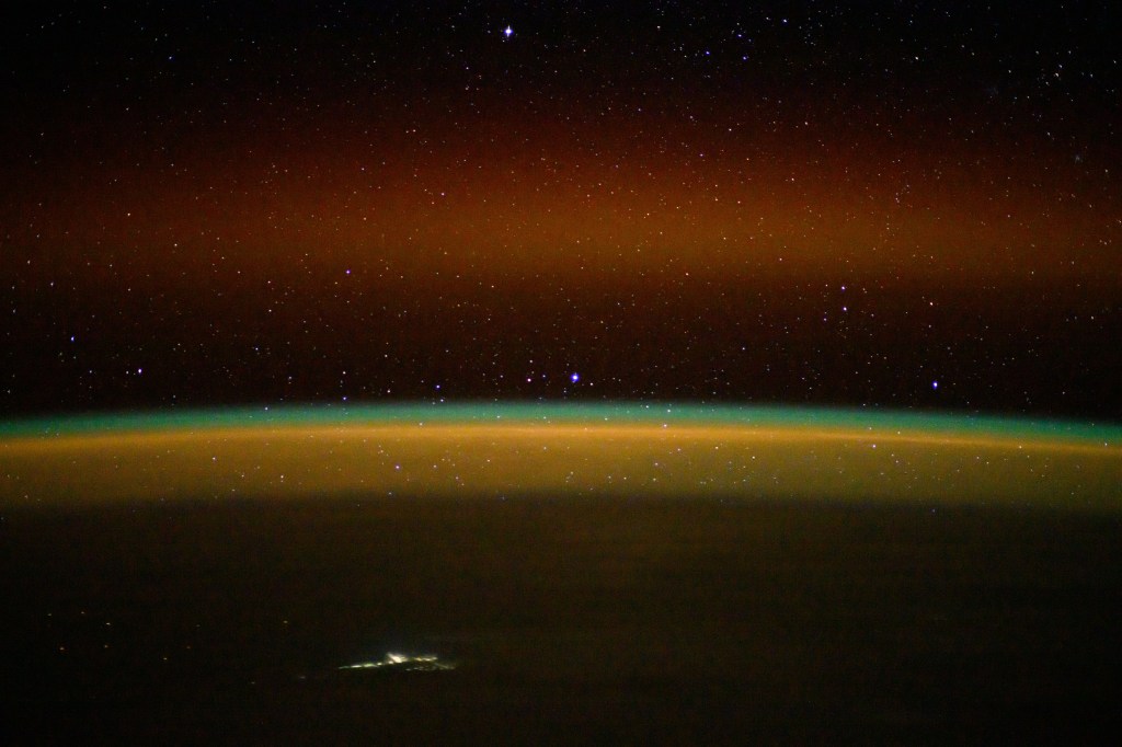 iss072e003466 (Sept. 29, 2024) -- As the International Space Station orbited 264 miles above the Northern Territory of Australia, NASA astronaut Jeanette Epps used long-exposure camera settings to capture an array of colors in Earth's horizon. A golden-green atmospheric glow crowns Earth's horizon, while stars shimmer above.