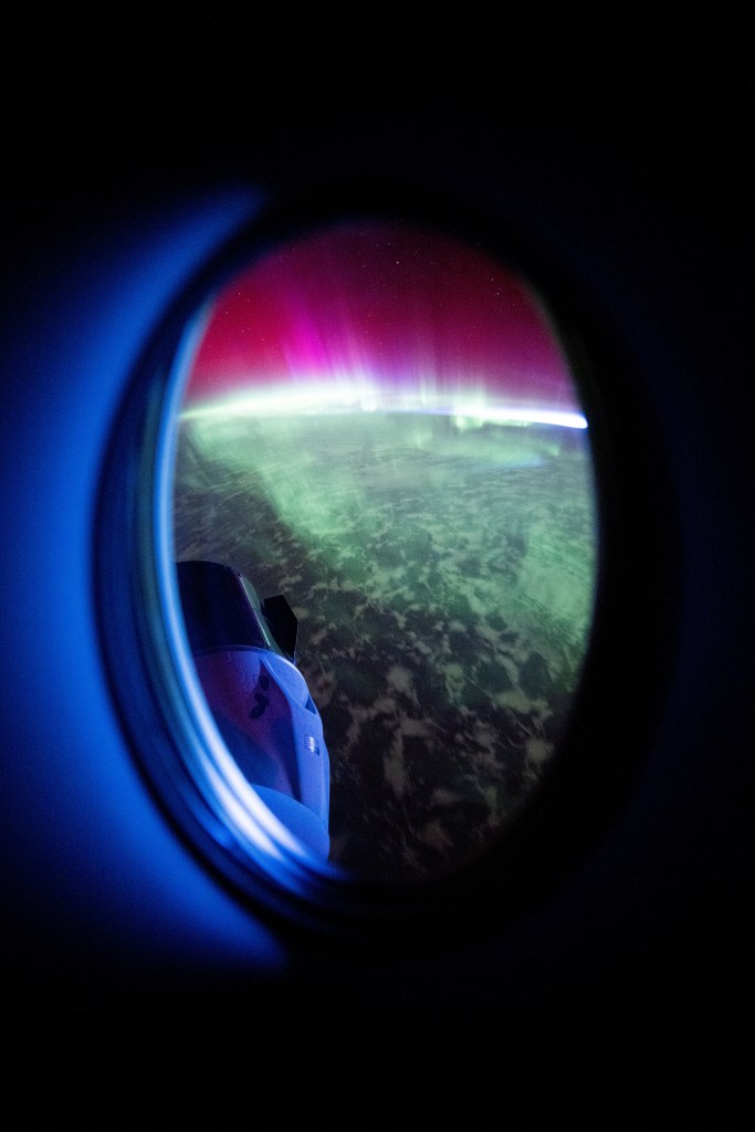 iss072e032577 (Oct. 7, 2024) -- The SpaceX Dragon Freedom spacecraft is pictured attached to the forward-facing port of the International Space Station's Harmony module as a vibrant aurora moves through Earth's atmosphere while the station orbited 273 miles above the Indian Ocean.