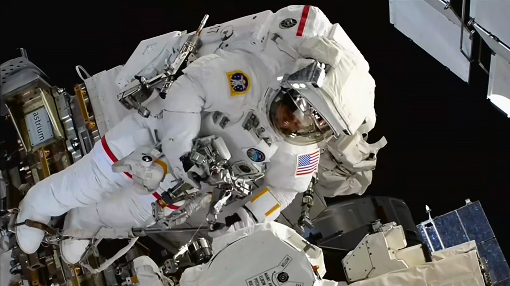 NASA astronaut Chris Williams works outside the International Space Station during a spacewalk to swap out a malfunctioning wrist joint on the Canadarm2 robotic arm.