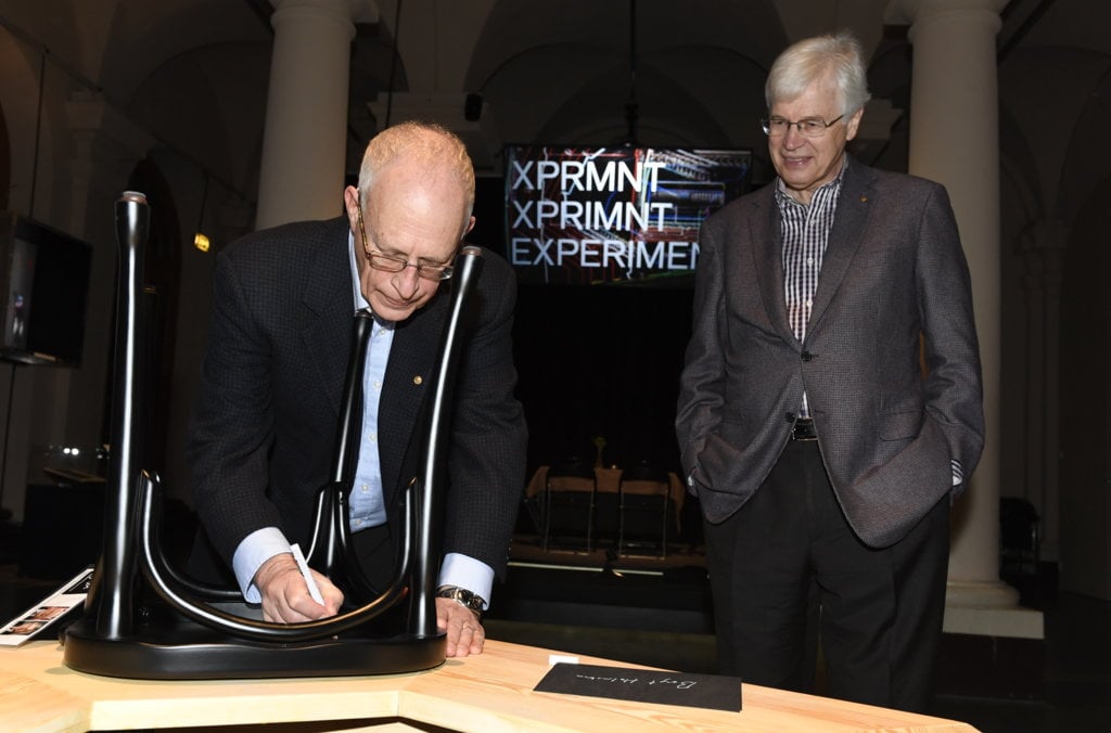 Bengt Holmström and Oliver Hart autograph a chair