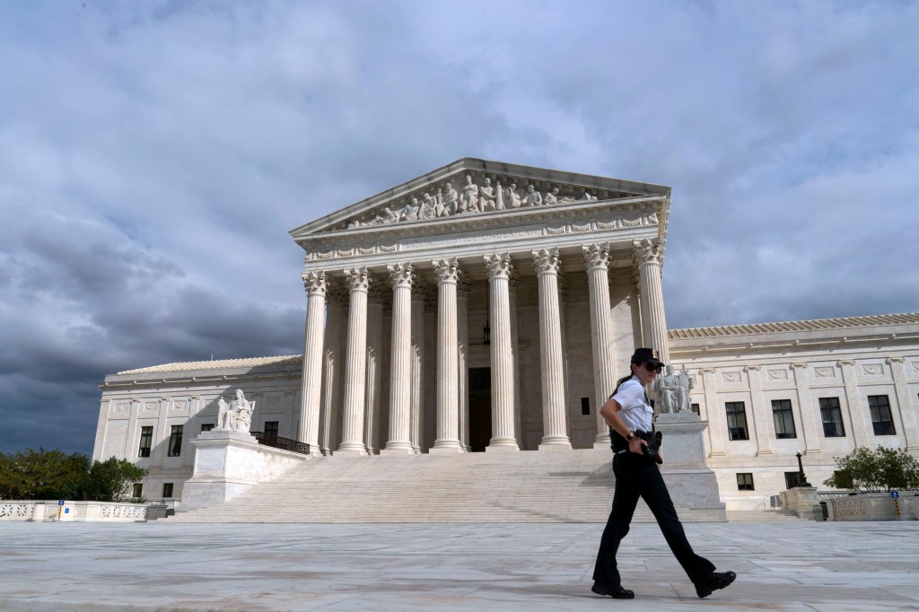 A U.S. Supreme Court police officer walks by during a voting rights rally, at the Supreme Court Oct. 28, 2021, in Washington. (AP Photo/Jose Luis Magana, File)