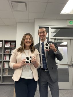 Ethan Launstein with his friend, both holding mugs shaped like cows